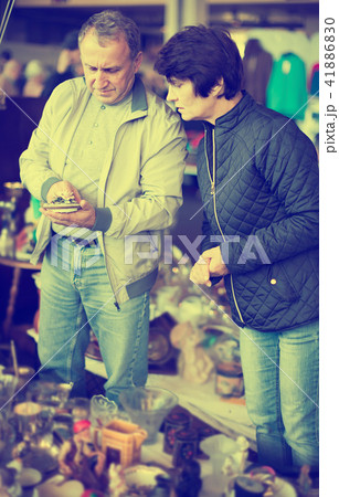 Modern man and woman at traditional flea market 41886830