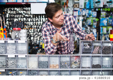 Employee selling nuts, screw and fasteners 41886910