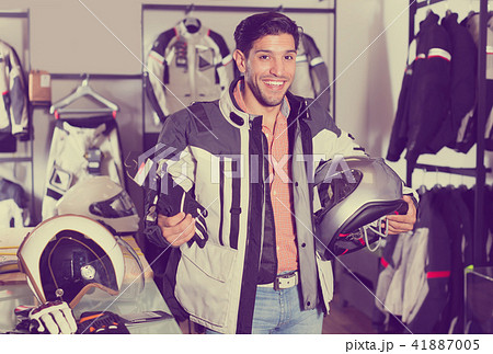Active man is choosing new gloves Active man is choosing new gloves 41887005