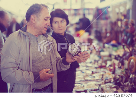 Senior couple looking vintage souvenirs at flea market 41887074