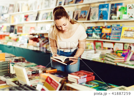 Woman buying textbooks Woman buying textbooks 41887259
