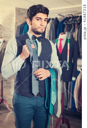 Person is picking up tie for waistcoat Person is picking up tie for waistcoat 41887318