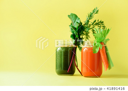 Healthy organic green and orange smoothies on 41891416