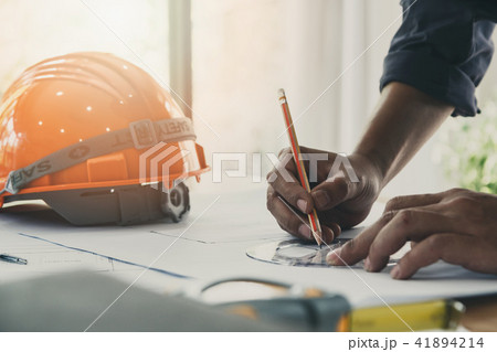 Architect or engineer working on blueprint Architect or engineer working on blueprint 41894214