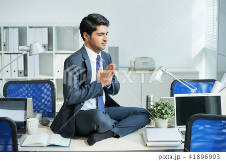 Businessman doing yoga 41896903