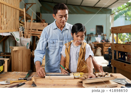 Father and son in workshop 41898650