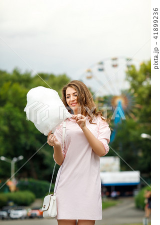 attractive woman holding sweet cotton candy attractive woman holding sweet cotton candy 41899236