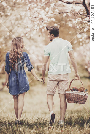 Young Couple Walking in Summer Park on Sunny Day. Young Couple Walking in Summer Park on Sunny Day. 41902981