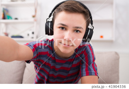 Boy in headphones taking selfie Boy in headphones taking selfie 41904336