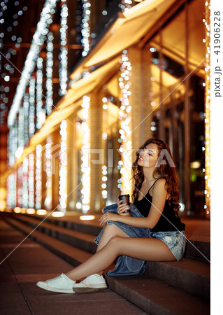 woman with coffee on the street 41906228