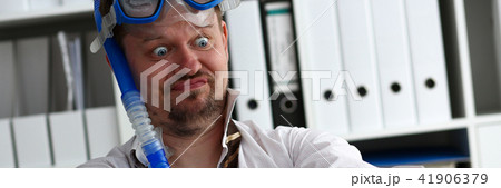 Man wearing suit and tie in goggles and snorkel 41906379