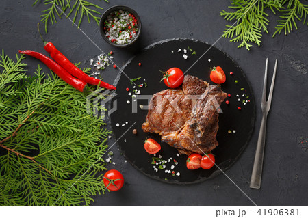 Rib eye steak on dark plate, top view Rib eye steak on dark plate, top view 41906381