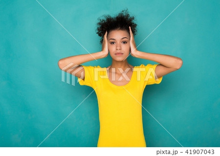 African-american woman puts her hands on head. 41907043