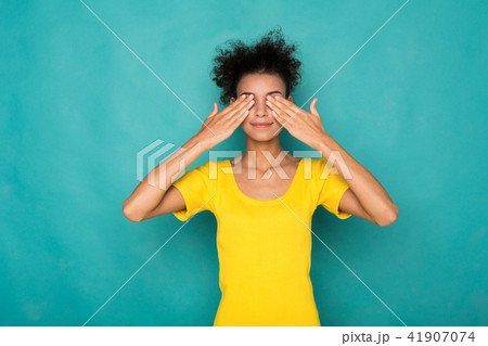 Black woman covering eyes with hands, see no evil Black woman covering eyes with hands, see no evil 41907074
