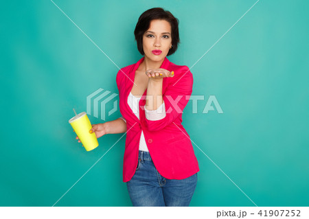 Happy girl in bright casual clothing at studio background 41907252