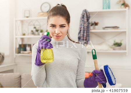 Woman with cleaning equipment ready to clean room 41907559
