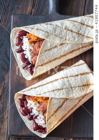 Chicken burritos on the wooden board Chicken burritos on the wooden board 41907744