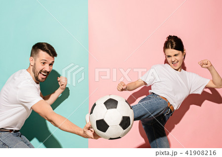 The young football fans plaing with ball on blue and pink trendy colors. 41908216