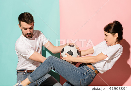 The unhappy and angry fans on colored blue and pink background. 41908394