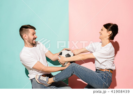 The unhappy and angry fans on colored blue and pink background. The unhappy and angry fans on colored blue and pink background. 41908439