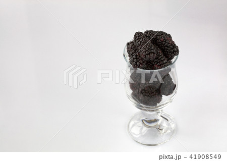 Red blackberry in clear glass on light background Red blackberry in clear glass on light background 41908549