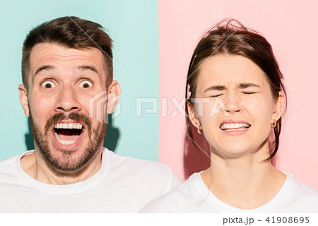 Closeup portrait of young couple, man, woman. One being excited happy smiling, other serious 41908695