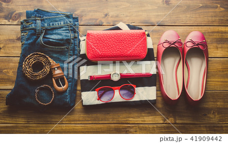 clothing for women, placed on a wooden floor. 41909442