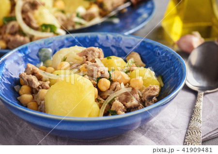 Stewed lamb with potatoes and chikpeas. Stewed lamb with potatoes and chikpeas. 41909481