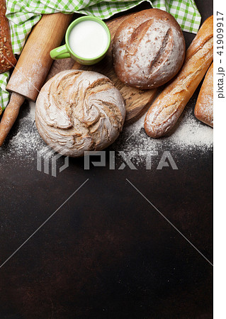 Various crusty bread and cup of milk 41909917