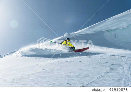 The total length of skiing on fresh snow powder. Professional skier outside the track on a sunny day The total length of skiing on fresh snow powder. Professional skier outside the track on a sunny day 41910873