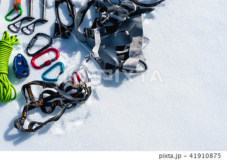 Winter set of equipment of an ice climber with carabiner wounds and a camp thermos. Copy space for Winter set of equipment of an ice climber with carabiner wounds and a camp thermos. Copy space for 41910875