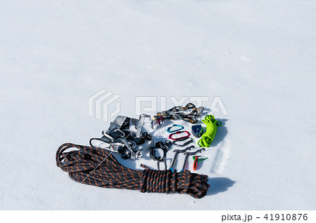 Winter set of equipment of an ice climber with carabiner wounds and a camp thermos. Copy space for Winter set of equipment of an ice climber with carabiner wounds and a camp thermos. Copy space for 41910876
