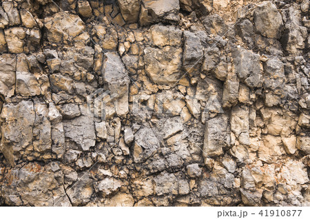 Pebble stones in a rocky wall. Natural background of a rocky stone wall Pebble stones in a rocky wall. Natural background of a rocky stone wall 41910877