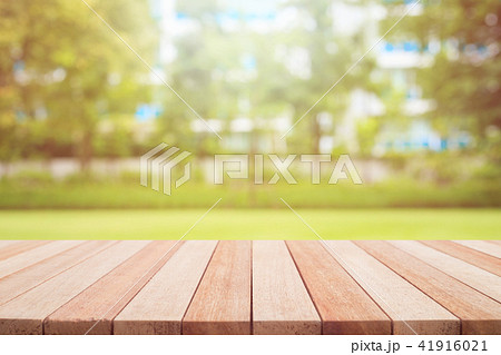Empty top wooden table and sunny abstract blurred bokeh background 41916021
