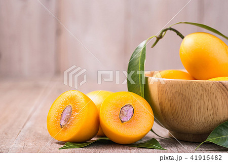 Fresh yellow marian plum fruit (Mayongchid in Thai name) on wooden table Fresh yellow marian plum fruit (Mayongchid in Thai name) on wooden table 41916482