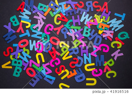 Colorful wooden alphabet. Top view on black stone. 41916516