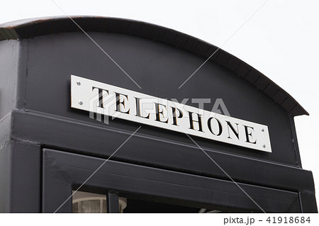 Vintage big black pay phone. 41918684