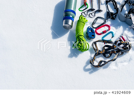 Winter set of equipment of an ice climber with carabiner wounds and a camp thermos. Copy space for Winter set of equipment of an ice climber with carabiner wounds and a camp thermos. Copy space for 41924609