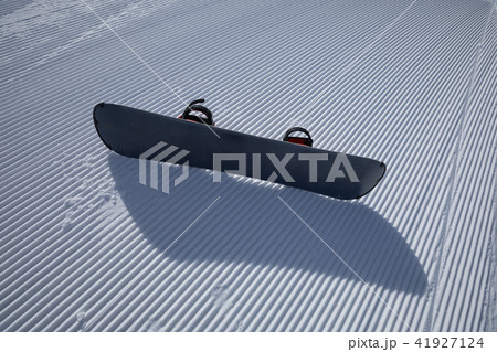snowboard on ski piste in winter mountain slope snowboard on ski piste in winter mountain slope 41927124