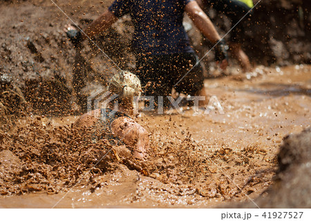 Mud race runners,during extreme obstacle races Mud race runners,during extreme obstacle races 41927527