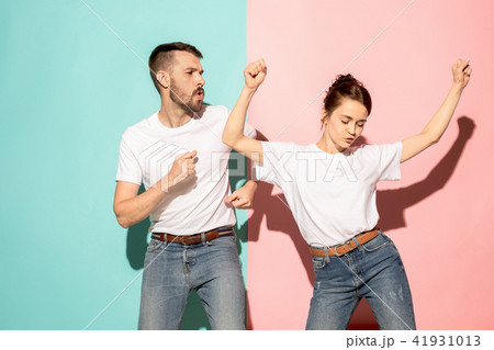 A couple of young man and woman dancing hip-hop at studio. A couple of young man and woman dancing hip-hop at studio. 41931013
