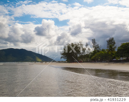 Sunny beach with green hills in the background. Sunny beach with green hills in the background. 41931229