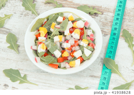 Centimeter and fresh salad in glass bowl Centimeter and fresh salad in glass bowl 41938628