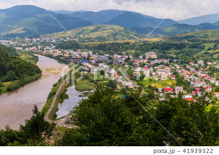 A town near a mountain river carrying a stream of A town near a mountain river carrying a stream of 41939322