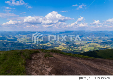 a road from a mountain leading to a valley between 41939520