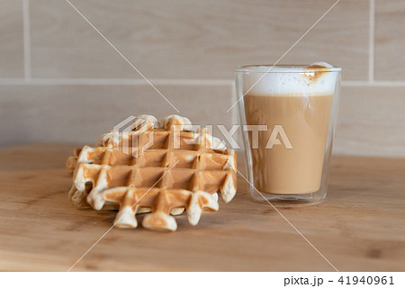 Glass cup of multilayer coffee with mini stroopwafel, syrupwaffles Glass cup of multilayer coffee with mini stroopwafel, syrupwaffles 41940961