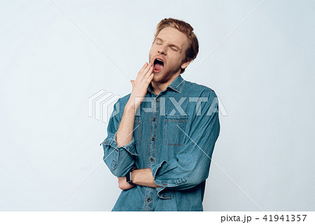 Portrait of Tired Sleepy Young Man Yawning Portrait of Tired Sleepy Young Man Yawning 41941357