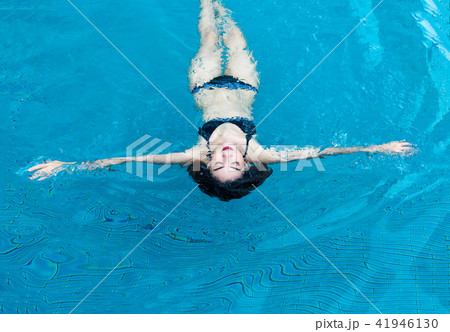 asian lady in swimming suite playing water posting on water pool 41946130