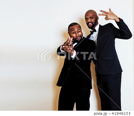 two afro-american businessmen in black suits emotional posing, g 41946153