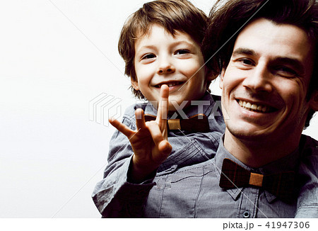 father with son in bowties on white background, casual look fami father with son in bowties on white background, casual look fami 41947306